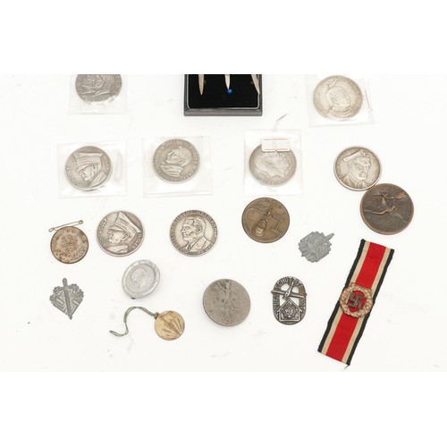 514 - A selection of German coins and medallions, sweetheart brooches and cap badges to include the 1935 A... 