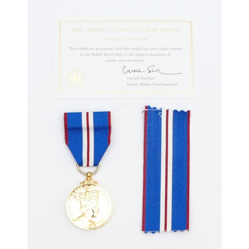 544 - A boxed Elizabeth II Golden Jubilee medal, with certificate of authentication.