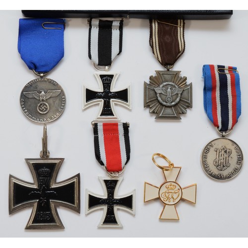 588 - A collection of seven medals, to include the Third Reich NSDAP 10 Year Service, together with replic... 