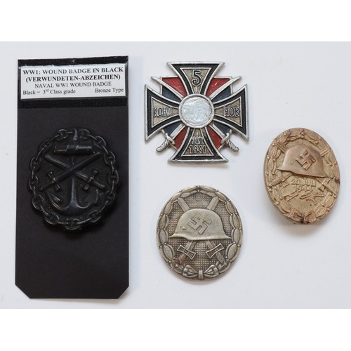 591 - A collection of four badges and medal, including a replica 5th Guards Don Coassack Cavalry Corp meda... 