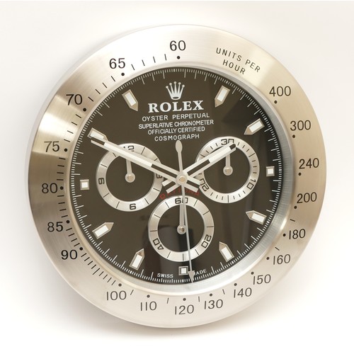 49 - A 'Rolex' style advertising metal wall clock, black dial 'Rolex Daytona Cosmograph', having quartz m... 