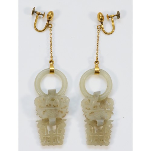 76 - A pair of carved jade screw back drop earrings, 70mm total drop, 43mm jade section, cracks to the ja... 