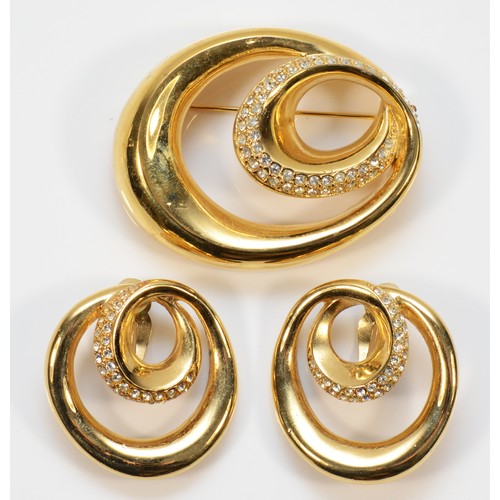 84 - Givenchy, a gilt metal and gemset brooch, 60mm, together with a pair of matching gilt metal gemset c... 