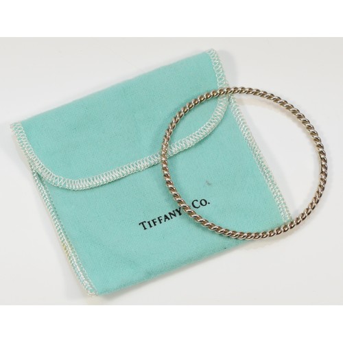 94 - Tiffany & Co, sterling silver twisted bangle with a pouch, Tiffany & Co London 2012, 60mm internal d... 