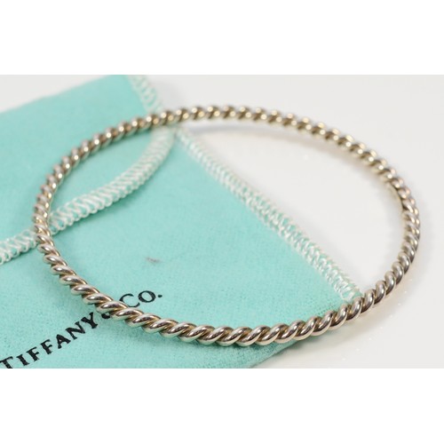 94 - Tiffany & Co, sterling silver twisted bangle with a pouch, Tiffany & Co London 2012, 60mm internal d... 