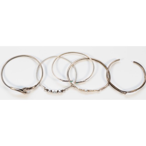 99 - Five silver and gemset bangles, to include a dolphin example, internal diameter from 60-65mm, 46g