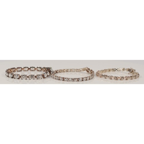 114 - Three 925 silver and cubic zirconia line bracelets, 18-19cm, 43g