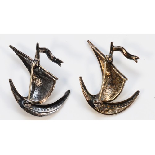 118 - Ivar T Holth, a 925 silver and enamel brooch in the form of a longboat, together with an identical v... 