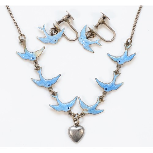 134 - A sterling silver and blue enamel swallow necklace, with a pair of matching screw back earrings, 38c... 