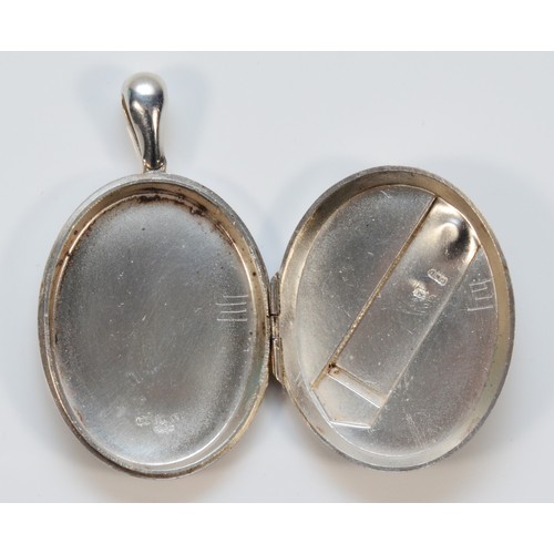 148 - A 925 silver locket, with engraving to verso and buckle detail to the front, Birmingham 1879, 18g