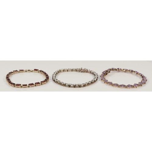 151 - Three 925 silver and gemset line bracelets, to include amethyst and garnet examples, 18-19cm, 37g