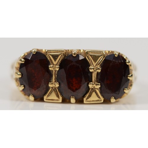 168 - A 9ct gold garnet three stone ring, P, 3.4g