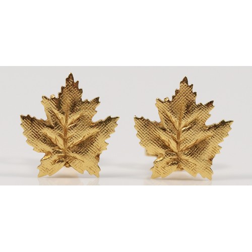 235 - A pair of 9ct gold maple leaf shaped earrings with scroll backs, 1g