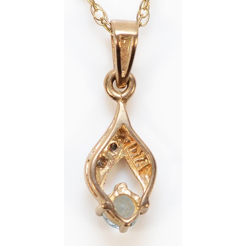 242 - A 9ct gold diamond and blue gemstone pendant with a chain, 1.1g