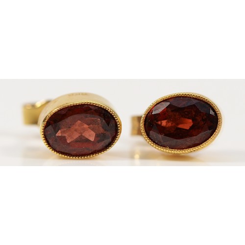 250 - A pair of 15ct gold garnet earrings with scroll backs, 1.6g