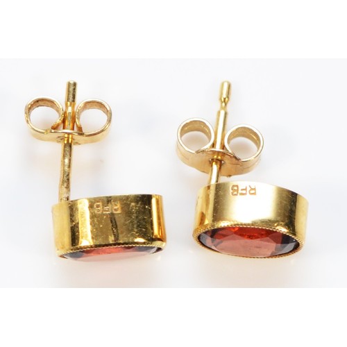 250 - A pair of 15ct gold garnet earrings with scroll backs, 1.6g