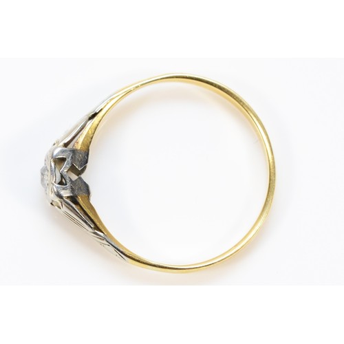 254 - An 18ct gold and platinum diamond single stone ring, with decorative shoulders, T, 2.6g