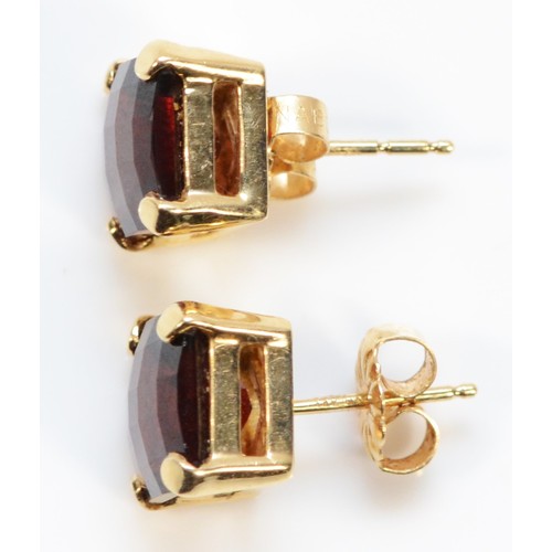 257 - A pair of 14k gold red gemstone earrings with scroll backs, 8mm x 8mm, 3.7g