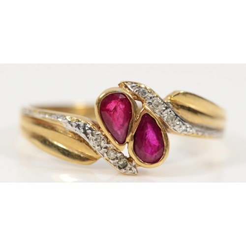 262 - A 9ct gold diamond and ruby cross over ring, P 1/2, 2.1g