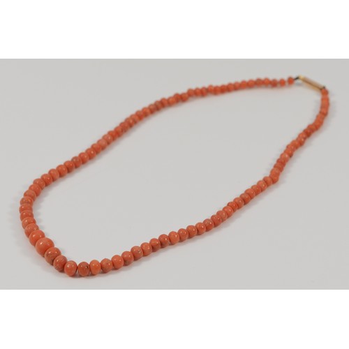 266 - A 9ct gold clasp beaded coral necklace, graduating bead size, largest 6mm, 12.3g