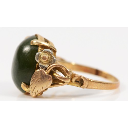 301 - A 9ct gold cabochon cut nephrite dress ring with foliate patterned shoulders, G 1/2, 2.9g