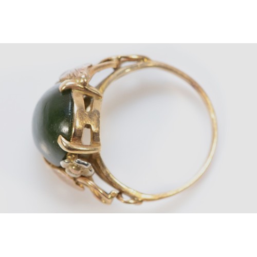 301 - A 9ct gold cabochon cut nephrite dress ring with foliate patterned shoulders, G 1/2, 2.9g