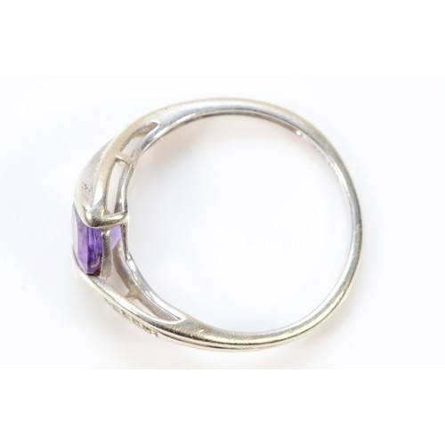 302 - A 9ct white gold amethyst and diamond cross over ring, N, 2g