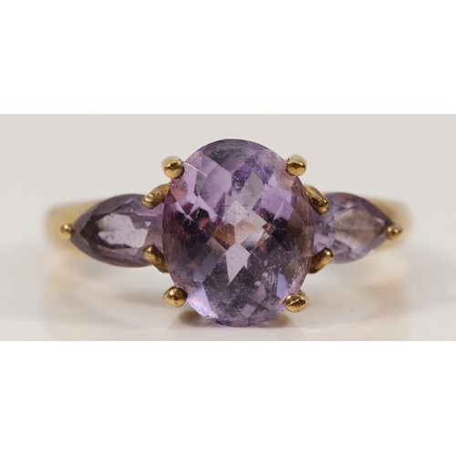 310 - A 9ct gold amethyst three stone ring, P 1/2, 3.9g