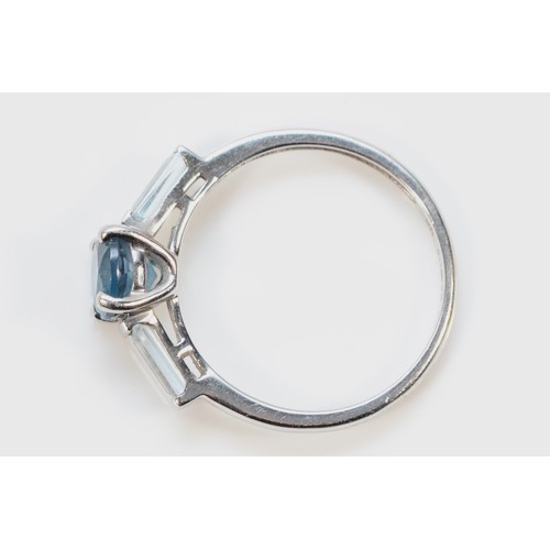 311 - A 9ct white gold blue gemstone three stone ring, M, 1.8g