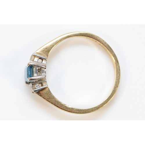 329 - A 9ct gold diamond and blue gemstone three stone ring, M, 2.4g