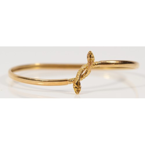 363 - A 14k gold twin headed snake bangle, 60mm internal, 5.8g