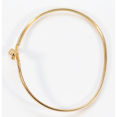 363 - A 14k gold twin headed snake bangle, 60mm internal, 5.8g