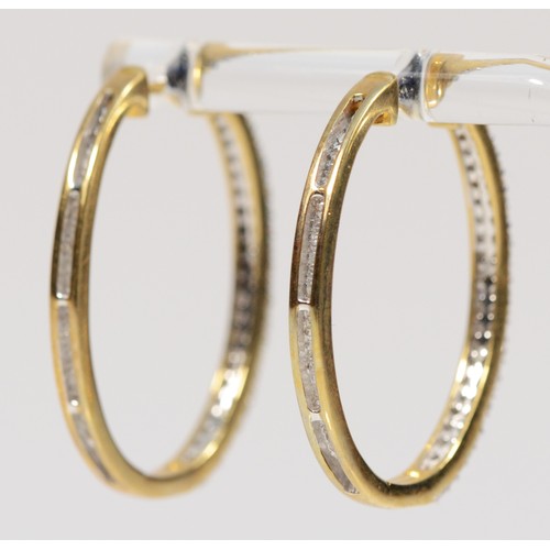 377 - A pair of 9ct gold diamond oval hoop earrings, 30mm, 5.3g