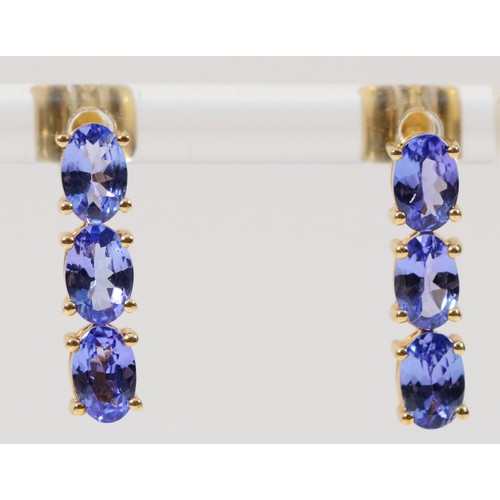 378 - A pair of 9ct gold tanzanite three stone drop earrings with scroll backs, 16mm, 2.5g