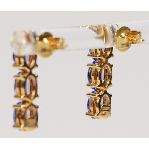 378 - A pair of 9ct gold tanzanite three stone drop earrings with scroll backs, 16mm, 2.5g