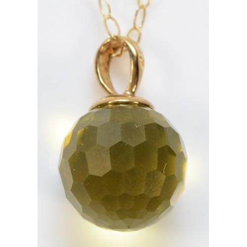 382 - A 9ct gold yellow gemstone sphere pendant on a chain, 10mm, 2.1g