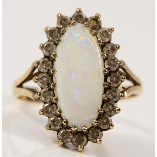 426 - A 9ct gold opal and white gemstone cluster ring, 15mm x 7mm opal, M, 3.3g