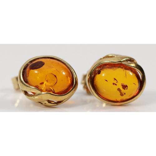 446 - A pair of 9ct gold amber earrings with scroll backs, 2.1g