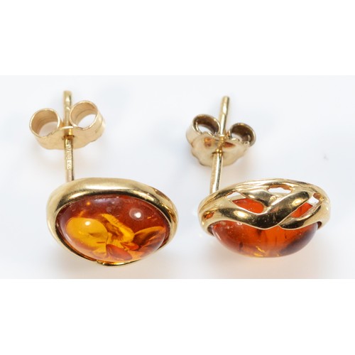 446 - A pair of 9ct gold amber earrings with scroll backs, 2.1g