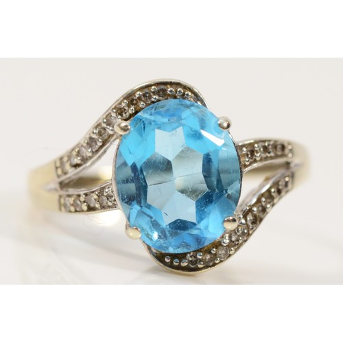 454 - A 9ct white gold diamond and topaz cross over ring, N, 2.8g