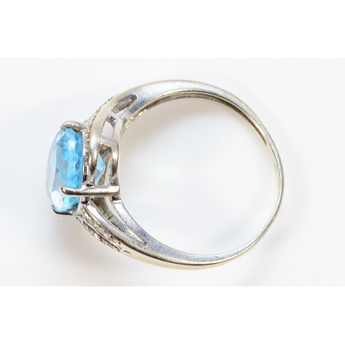 454 - A 9ct white gold diamond and topaz cross over ring, N, 2.8g