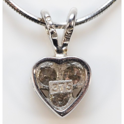 481 - A 9ct white gold brilliant cut diamond heart shaped pendant with a chain, 2.5g