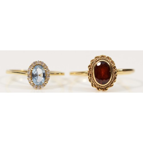 509 - A 9ct gold red gemstone dress ring, N, together with a 9ct gold blue and white gemstone dress ring, ... 