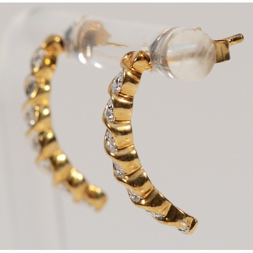 512 - A pair of 9ct gold diamond half hoop earrings with scroll backs, 15mm, 1.8g