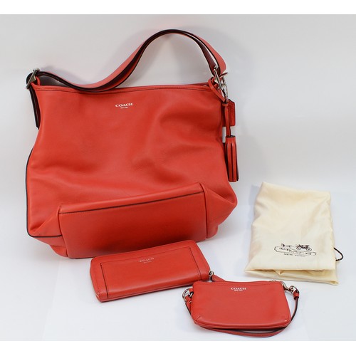 A red leather Coach shoulder bag, with external zippered pouch and