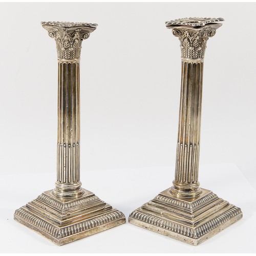 11 - A silver pair of Corinthian column candlesticks, by Goldsmiths & Silversmiths company, London 1911, ... 