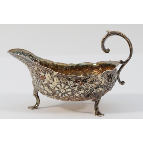 16 - A Victorian silver sauce boat, London 1889, with embossed and chased floral decoration, 11.5cm, 79gm