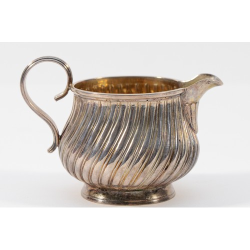 34 - A Victorian silver ribbed cream jug, by Charles Stuart Harris, London 1882, 6cm tall, 55gm, cased.