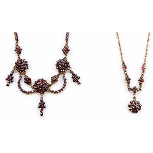 65 - An Austro-Hungarian gilt metal and Bohemian garnet triple cluster and swag necklace, the front 12cm,... 