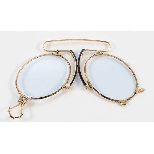 99 - An Edwardian pair of 14K gold Pinz Nez, by WE, with engraved decoration.